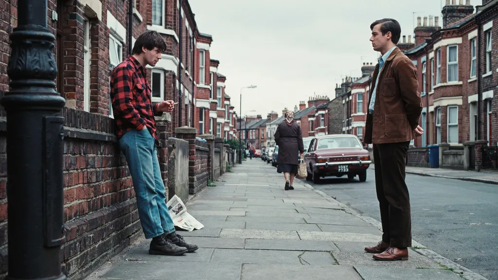The two brothers standing in an old London street looking at each other.